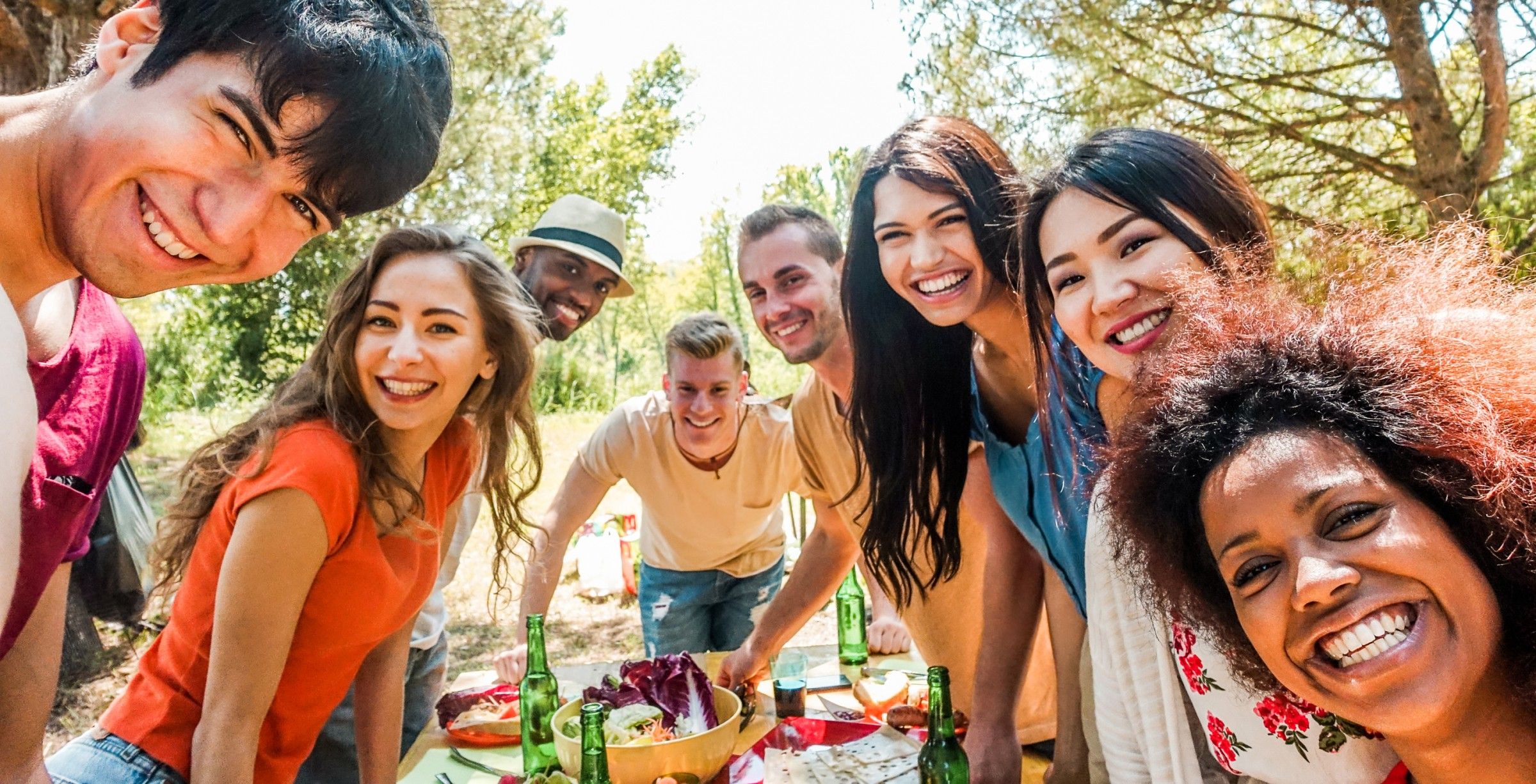 Windshire Terrace Apartments A group of diverse friends smiling together during an outdoor picnic.